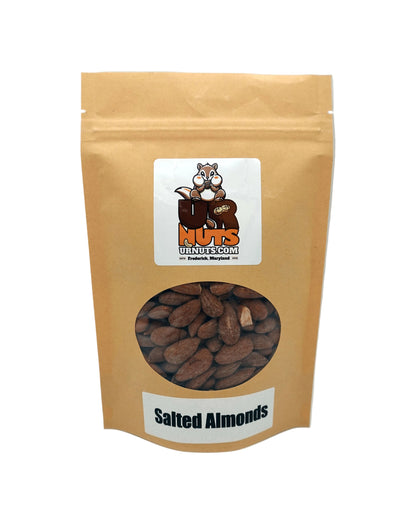 A stand-up kraft paper pouch of 'UR Nuts' brand Salted Almonds, featuring a clear circular window showing the almonds inside, set against a neutral light gray background.