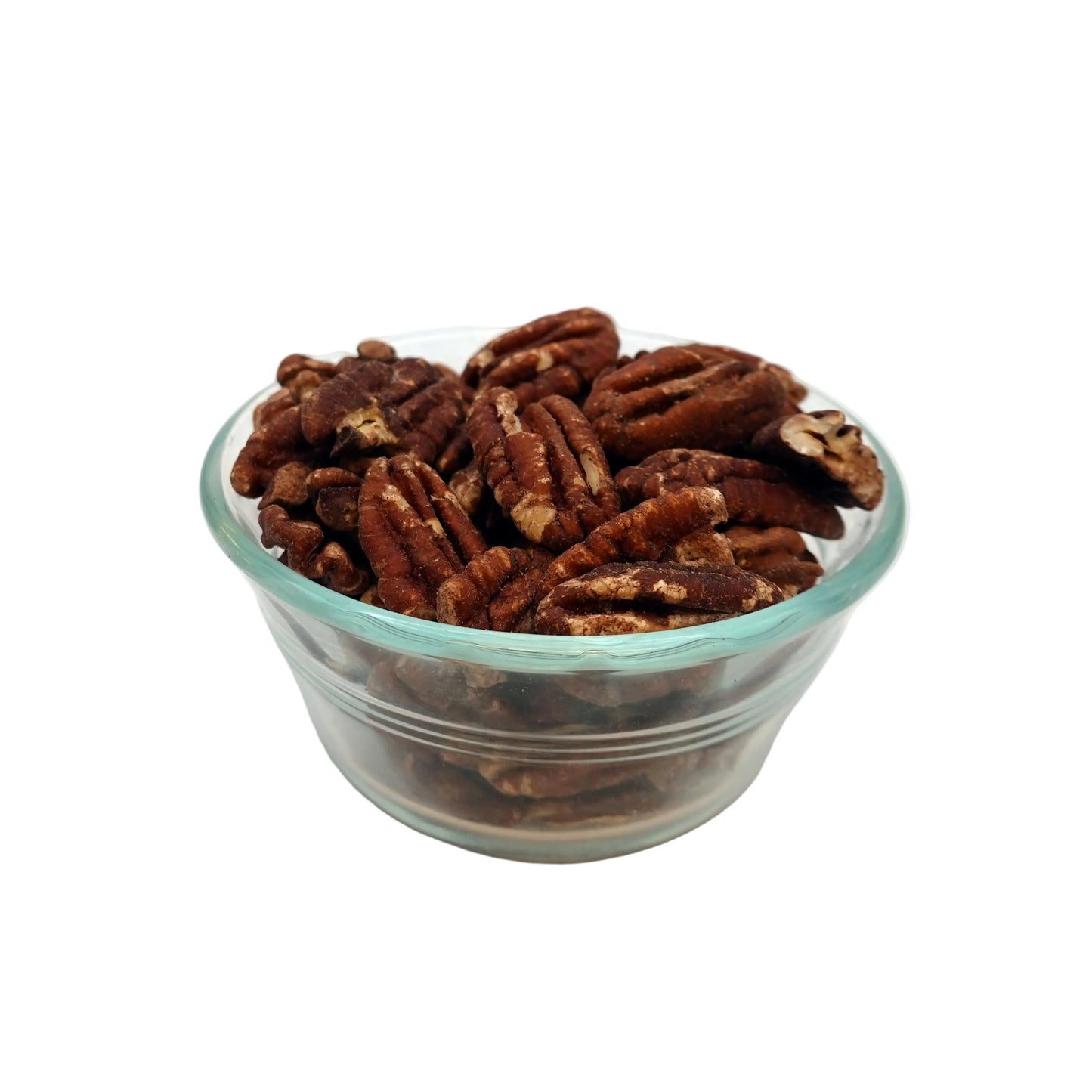 A clear glass bowl filled with brown salted pecans on a white studio background.