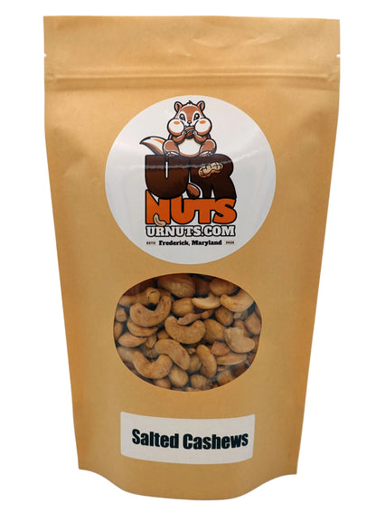 A stand-up kraft paper pouch of UR Nuts Salted Cashews, featuring a circular white logo with a cartoon nut on the front and a clear window showing the cashews inside.