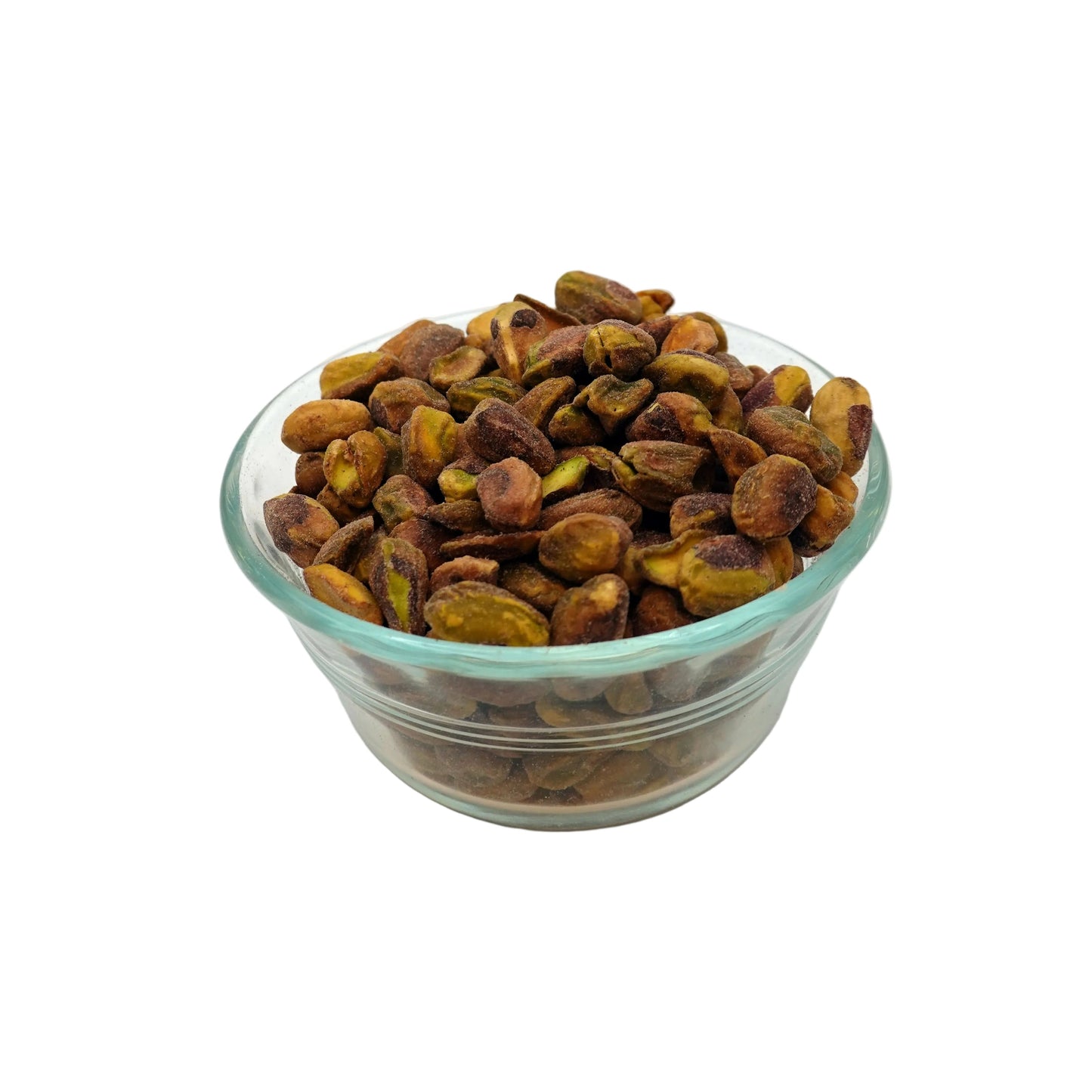 A clear glass bowl filled with roasted salted pistachios on a clean white background.