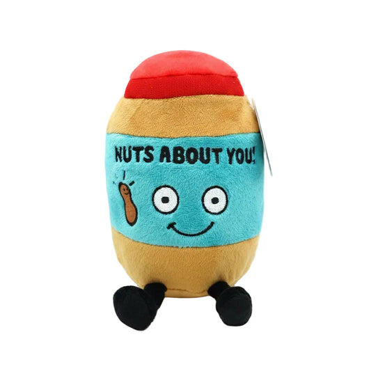 A plush peanut jar toy with a red top, tan sides, a light blue center panel reading 'NUTS ABOUT YOU!' with a smiling face, black legs, and a gray hangtag on a white background.