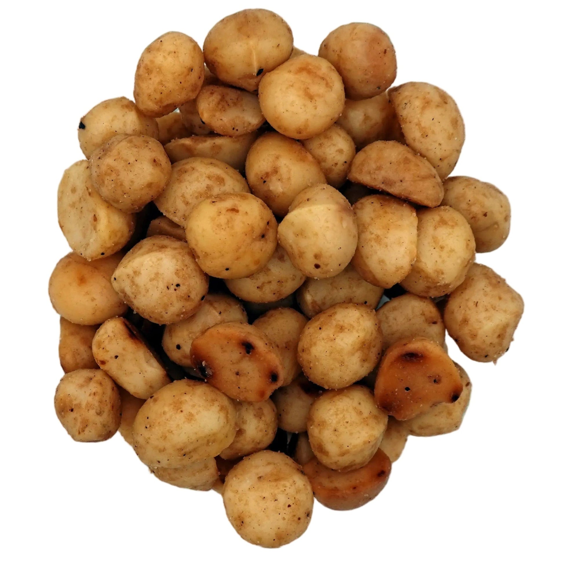 A top-down view of roasted salted macadamias in a clear glass bowl on a white background.