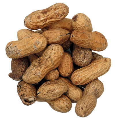 A top-down view of unsalted in-shell peanuts in their natural tan and brown shells, presented in a small clear glass bowl on a clean white background.