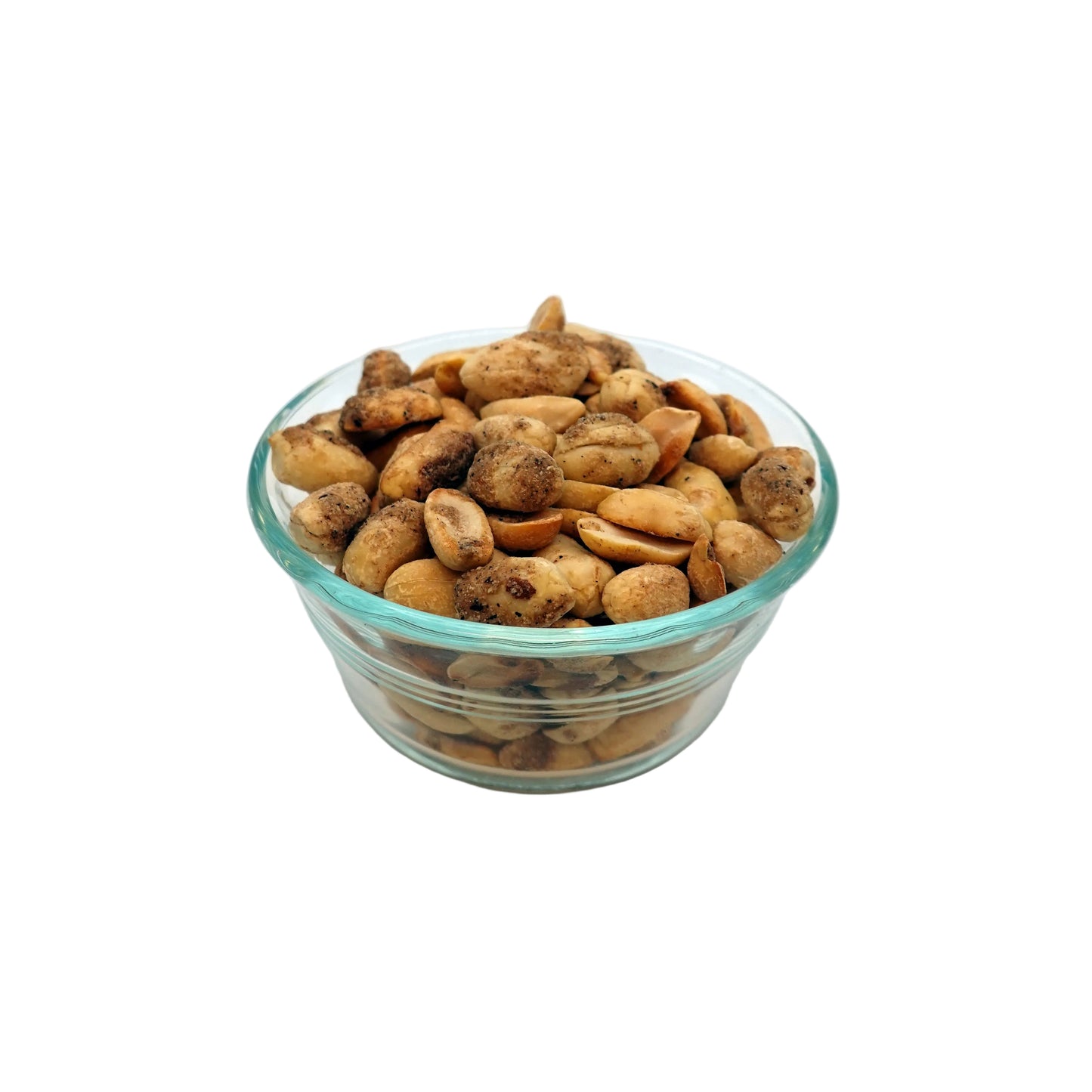A clear glass bowl filled with sliced light brown nuts, photographed on a plain white studio background.