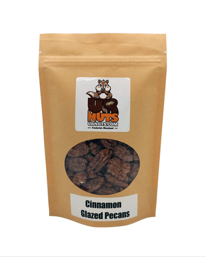 A stand-up kraft paper pouch of Cinnamon Glazed Pecans from UR Nuts, featuring a clear window showing the glazed pecans inside and a cartoon squirrel logo on the front label.