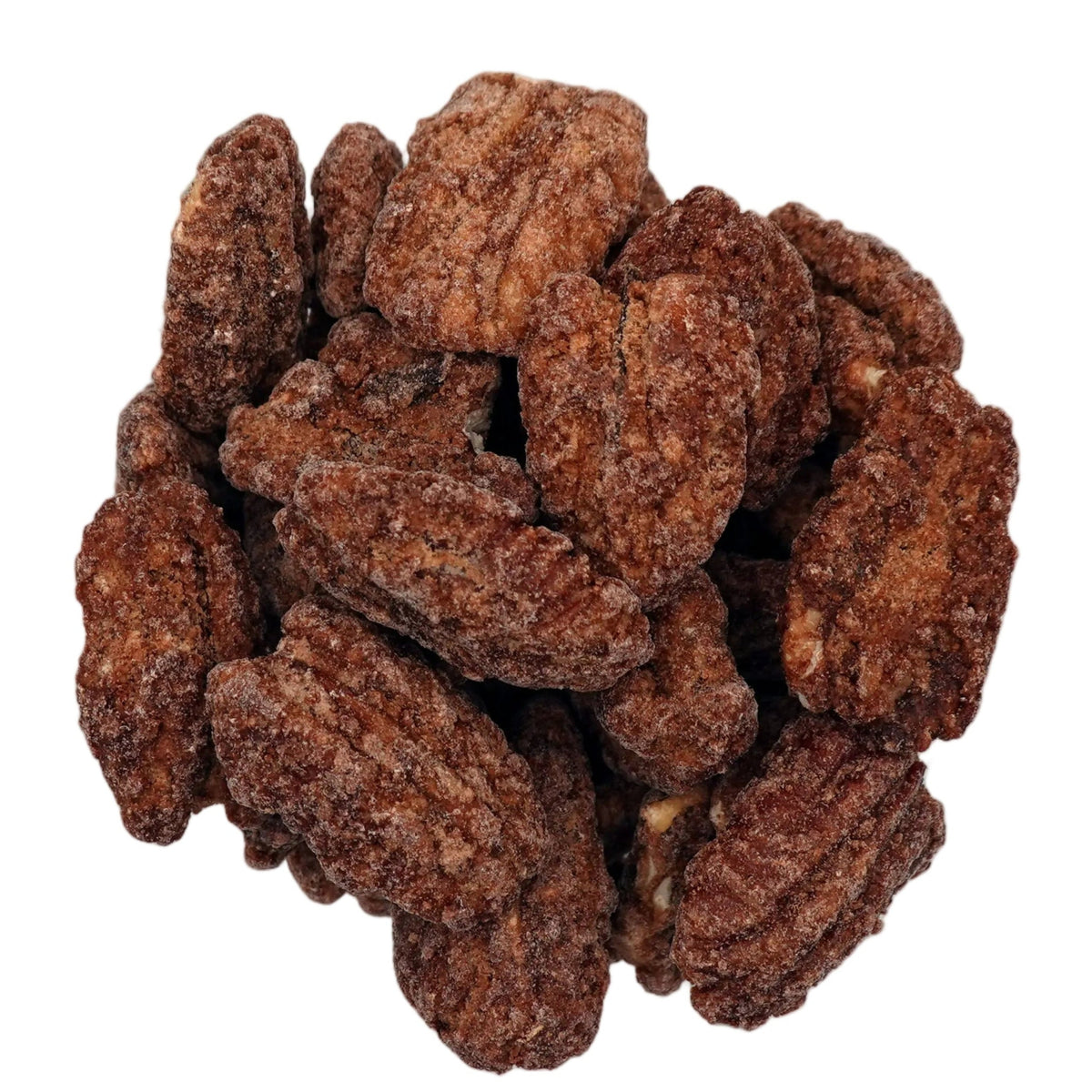 A top-down view of cinnamon glazed pecans piled in a clear glass bowl on a white background.