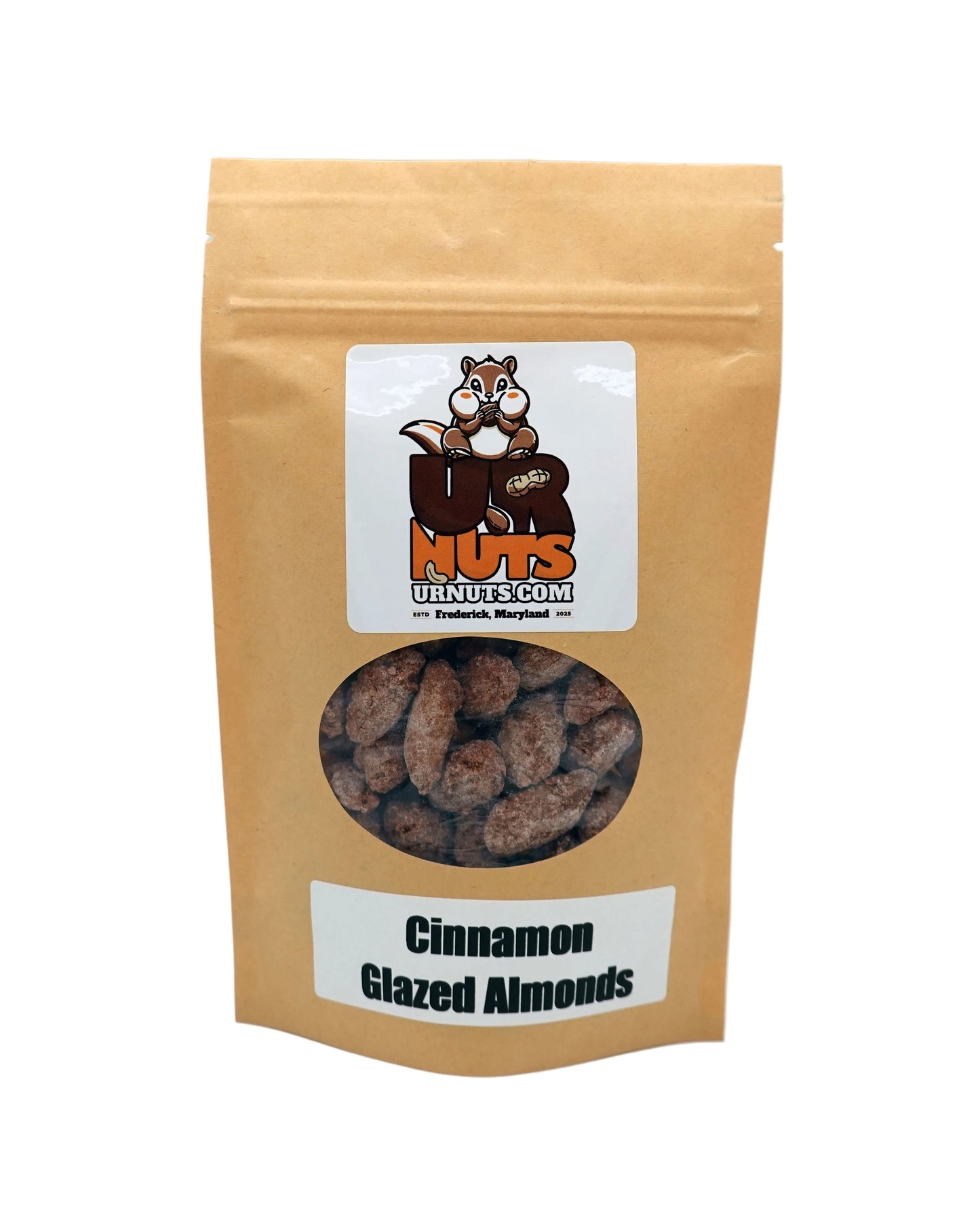 A stand-up kraft paper pouch of UR Nuts Cinnamon Glazed Almonds, featuring a clear window showing the almonds inside and a white label with the brand logo.