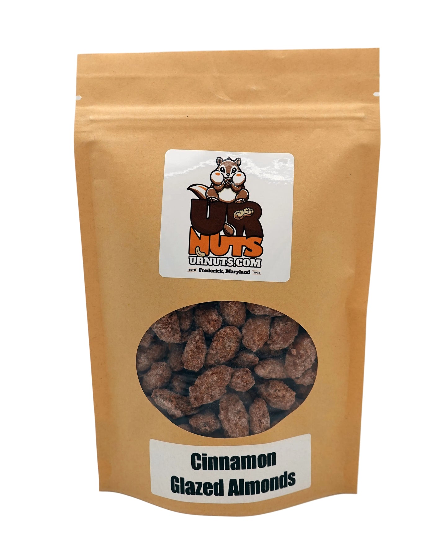 A stand-up kraft paper pouch of UR Nuts Cinnamon Glazed Almonds, featuring a clear circular window showing the almonds inside and a white label with the brand logo.