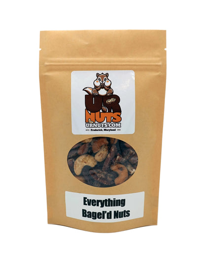 A stand-up kraft paper pouch of 'Everything Bagel'd Nuts' by UR Nuts, featuring a clear window showing mixed nuts inside and a cartoon squirrel logo on the front label.
