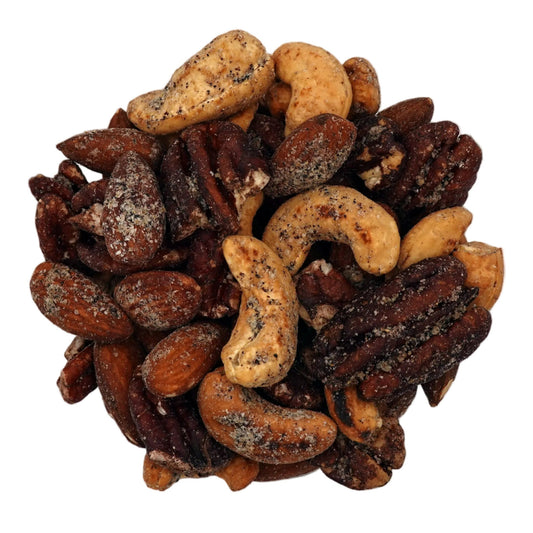 A clear glass bowl filled with Everything Bagel Seasoned Nuts, photographed from above on a plain white background.