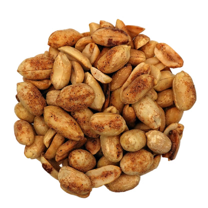 Roasted savory cajun peanuts in a clear glass bowl, photographed from a top-down view on a clean white background.